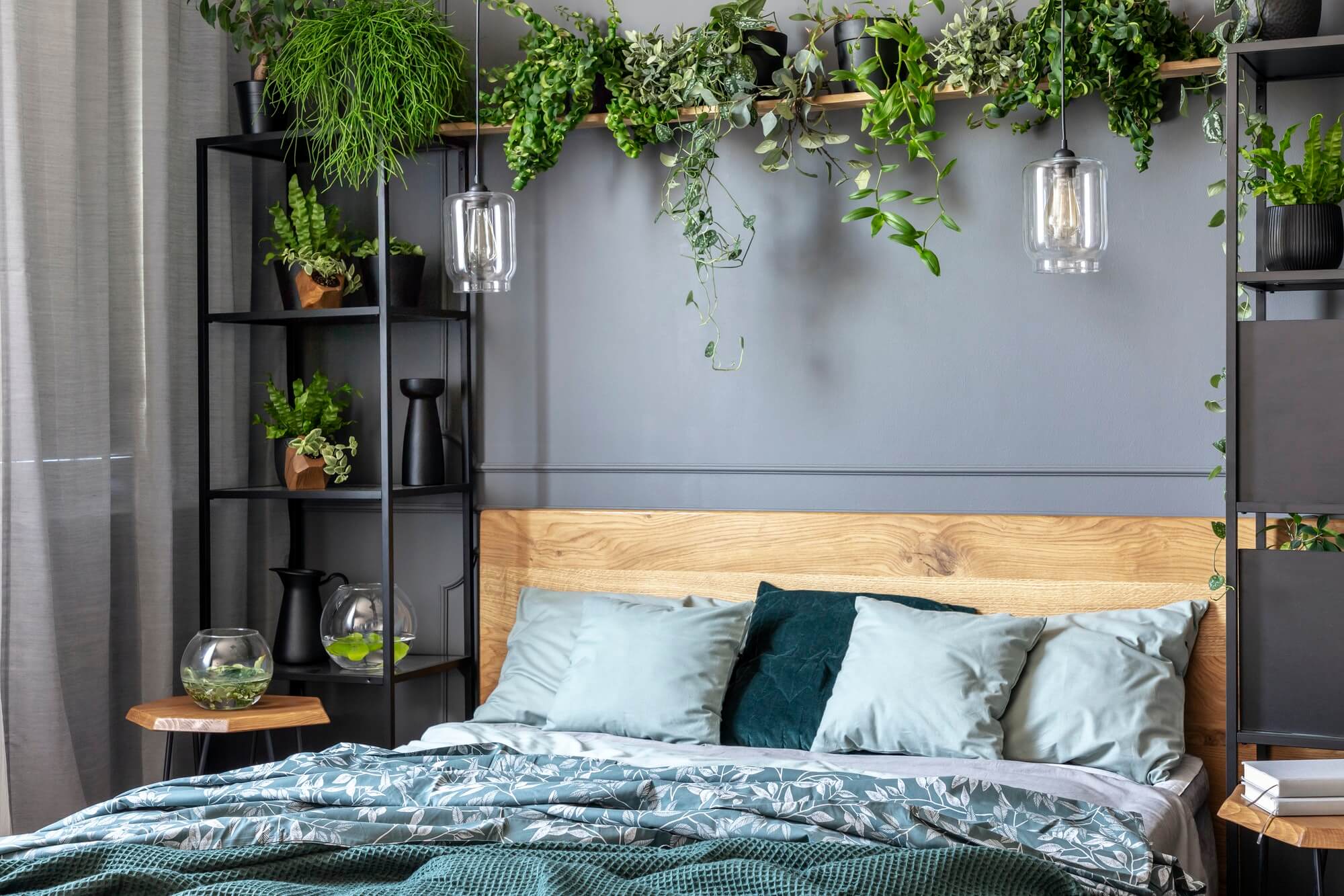 grey-pillows-on-wooden-bed-in-dark-bedroom-interior-with-lamps-a.jpg